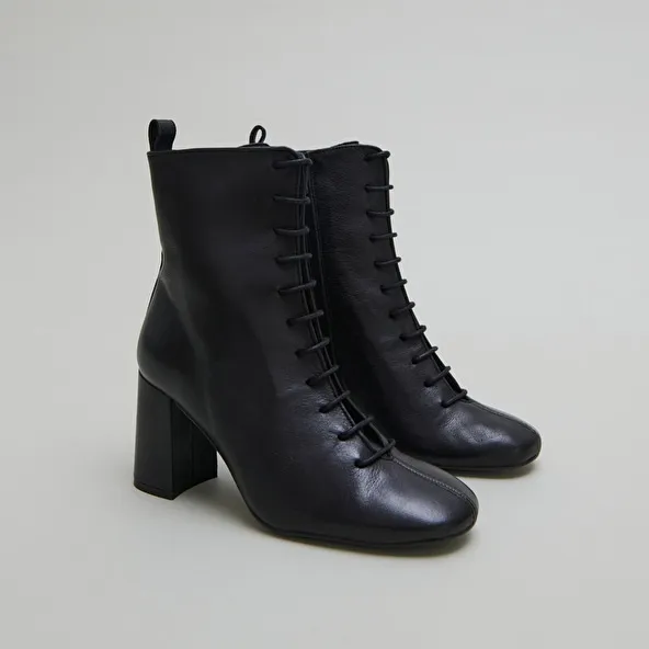 Heeled and lace-up ankle boots in black leather